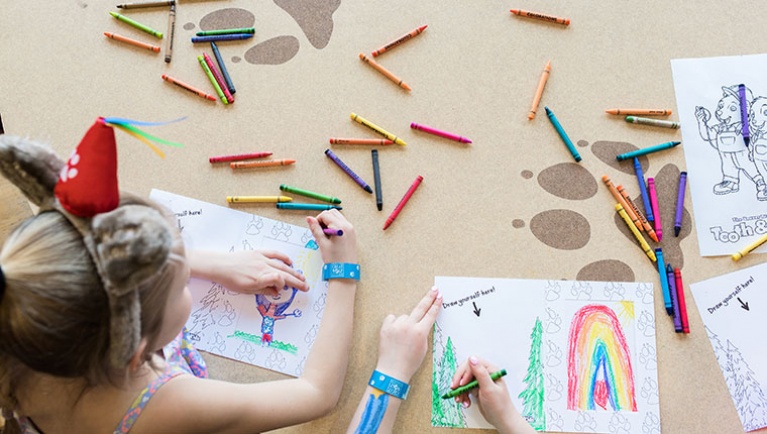 Kids use crayons to color 