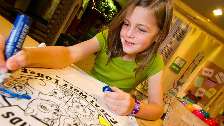 A girl uses a marker to color