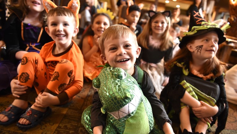an employee and character read a book to children 