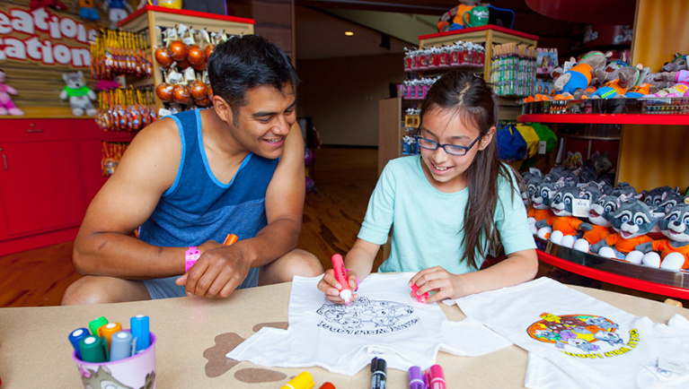 A father and daughter participate in arts and crafts