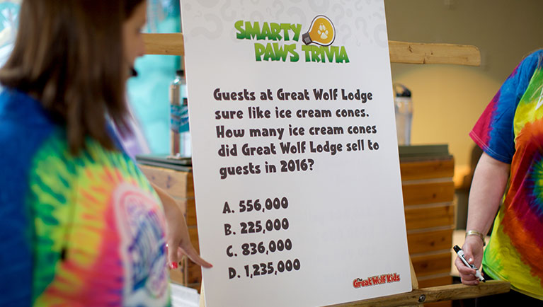 employees in tie dyed shirts lead trivia