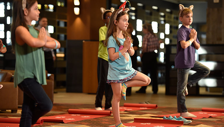 families take part in a yoga class
