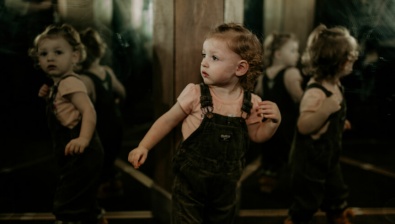 A girl looks at mirrors in Moonstone Mine at Great Wolf Lodge indoor water park and resort.