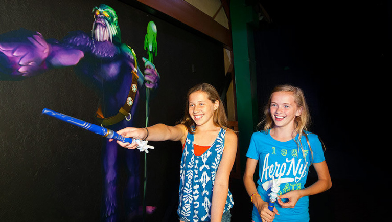 Two girls play ShadowQuest at Great Wolf Lodge indoor water park and resort.