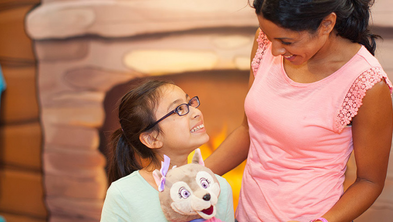 A girl smiles at her mother after a visit to Creation Station at Great Wolf Lodge indoor water park and resort.
