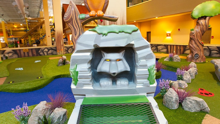 A wolf statue at Howl at the Moon Mini Golf at Great Wolf Lodge indoor water park and resort.