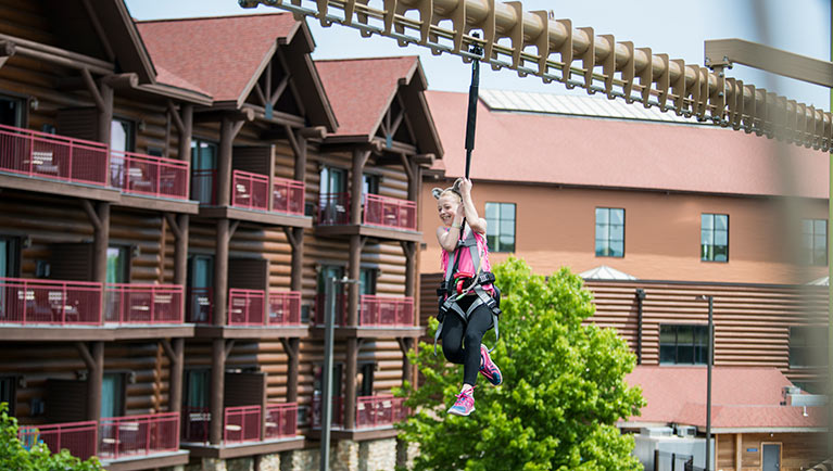 A family attemptes the Howlers Peak Ropes Course at Great Wolf Lodge indoor water park and resort.