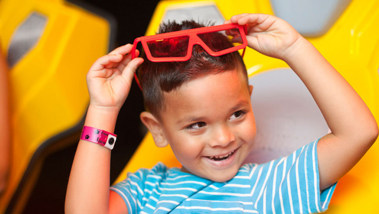 A boy takes off his 3D glasses inside the Howly Wood XD Theater at Great Wolf Lodge indoor water park and resort.