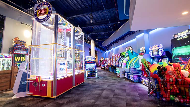 A wide shot of the many games at Northern Lights Arcade at Great Wolf Lodge indoor water park and resort.