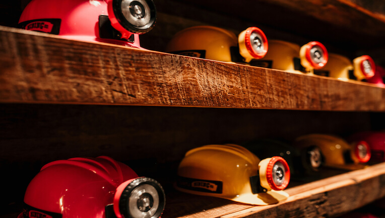 Shelves of mining hats at Oliver's Mining Co.
