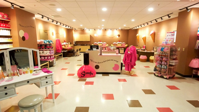 Various beauty stations and products inside Scooops Kid Spa at Great Wolf Lodge indoor water park and resort.