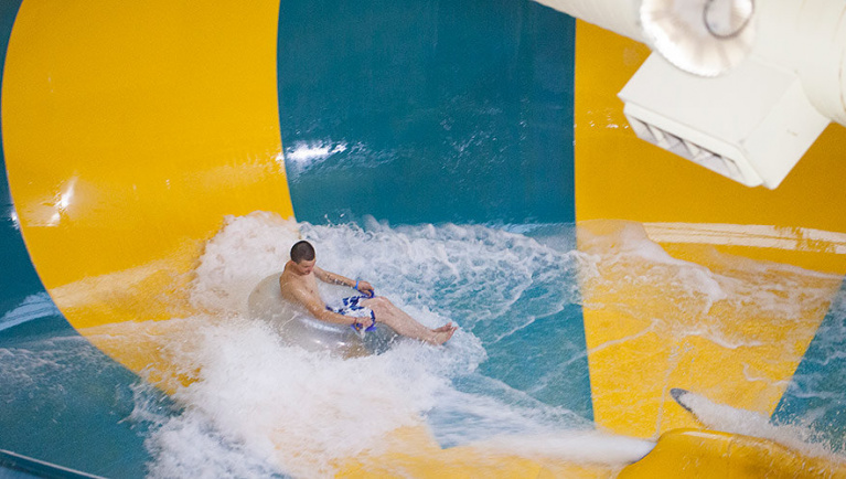 A guest enjoing the Coyote Cannon water slide at Great Wolf Lodge indoor water park and resort.