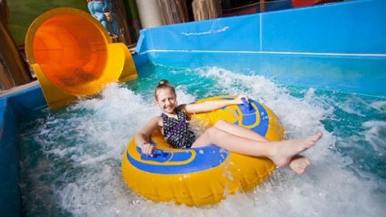 A girl rides a tube at Rapid Racer at Great Wolf Lodge