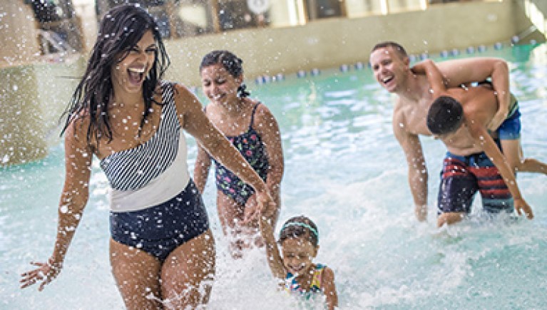 A family playing in water at Slap Tail pond at Great Wolf Lodge