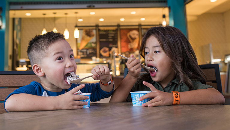 Two children enjoy some ice cream