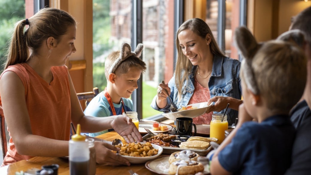 A smiling family having breakfast at Great Wolf Lodge