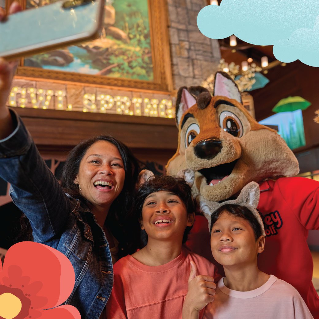 Family taking a picture with Great Wolf Lodge Characters