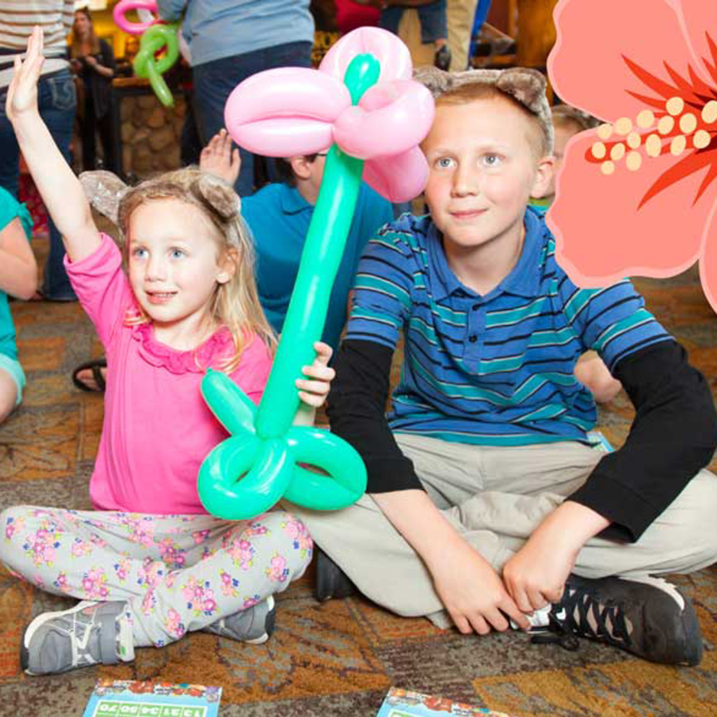 kids sitting in the main lobby with flower balloons playing bingo
