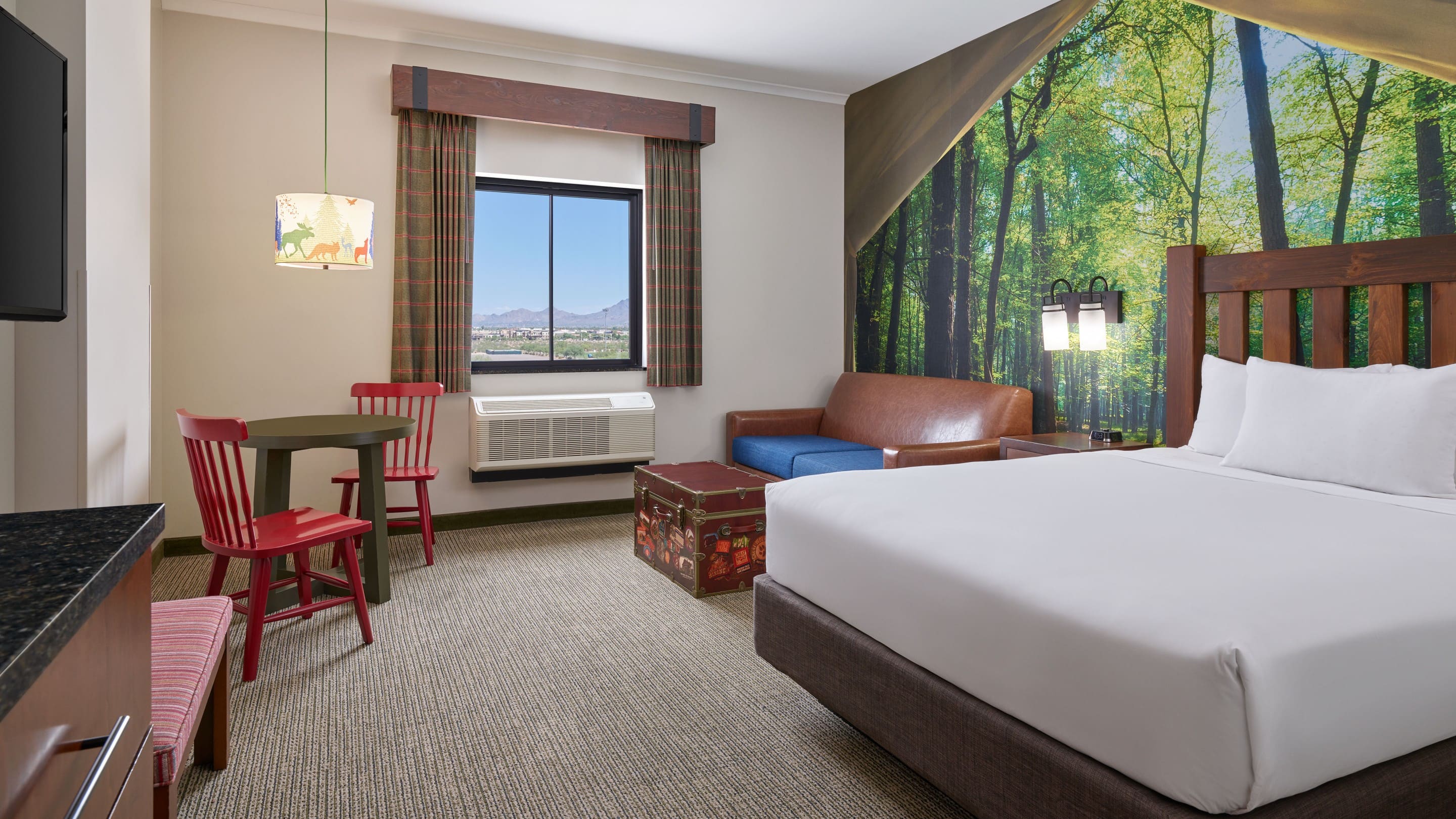 Bed and sofa in the Wolf Den Suite