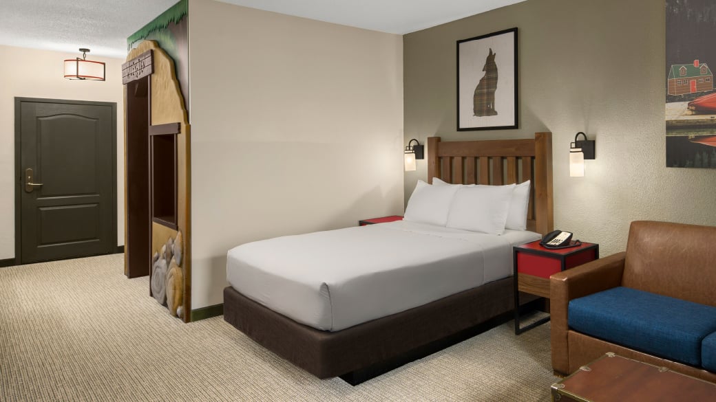 The bed and sofa in the Deluxe Wolf Den Suite