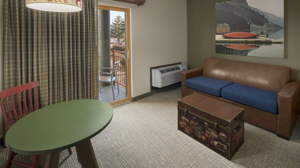 The bed and living space in the Queen Sofa Suite (accessible bathtub)