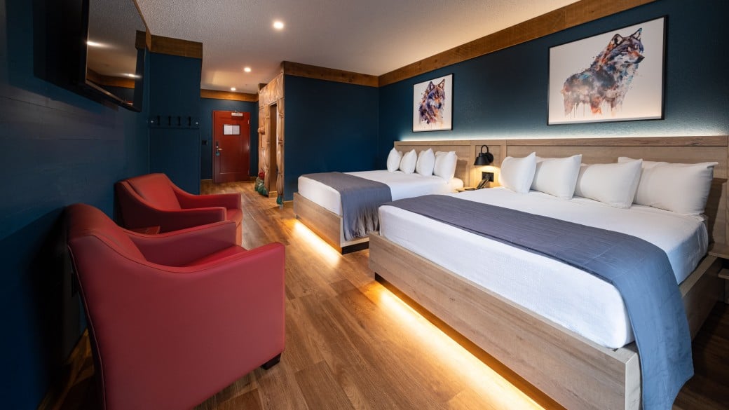 The queen beds in the KidKamp Suite