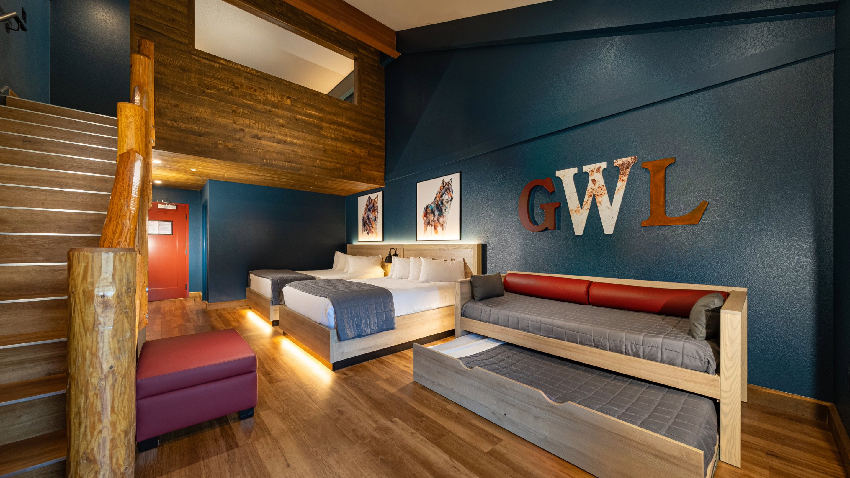 View of the day bed, trundle bed, and two queen beds in the Loft Fireplace Suite