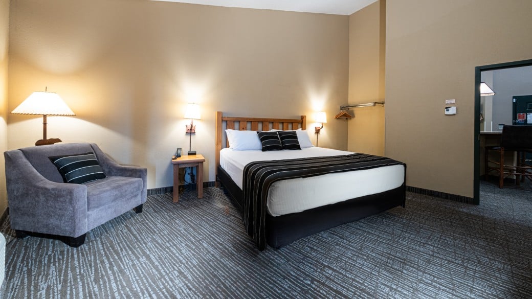 The bed alongside sofa in the Majestic Bear Suite