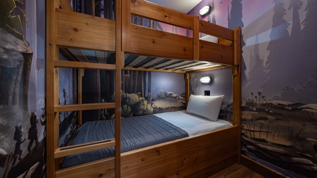 Indoor cabin with bunk beds in the Wolf Den Suite