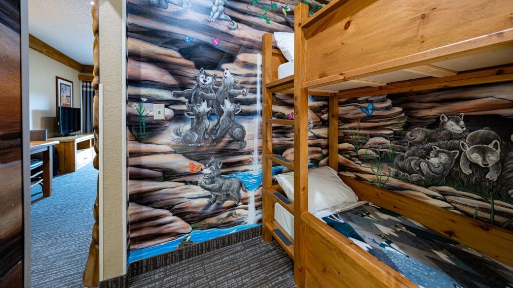 Indoor cabin with bunk beds in the Wolf Den Suite