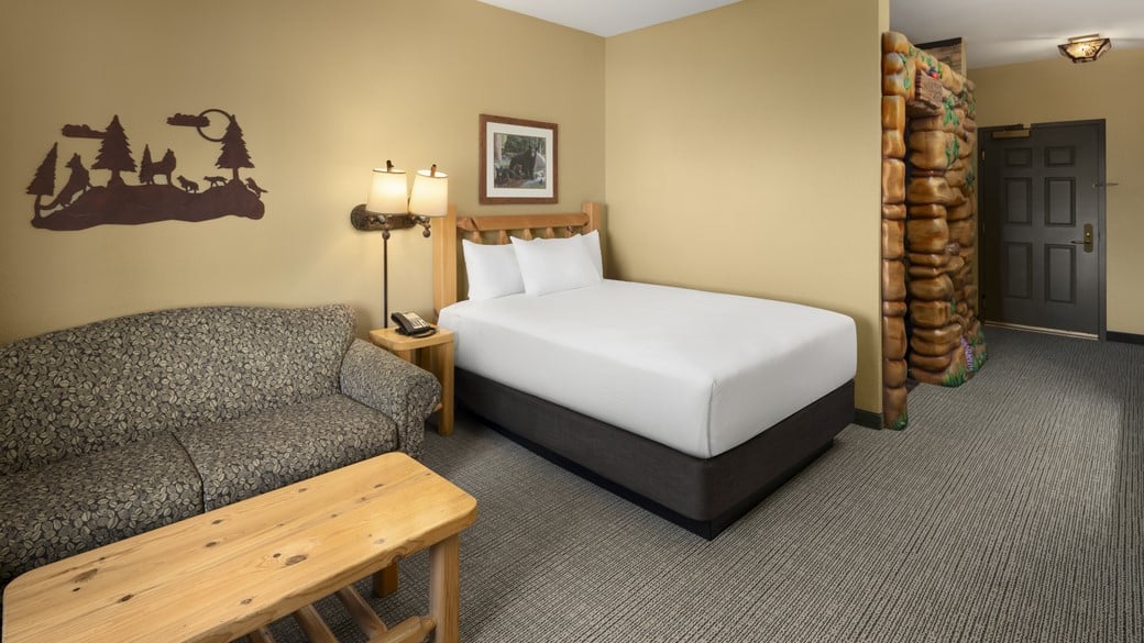 The sofa and bed in the Deluxe Wolf Den King Suite