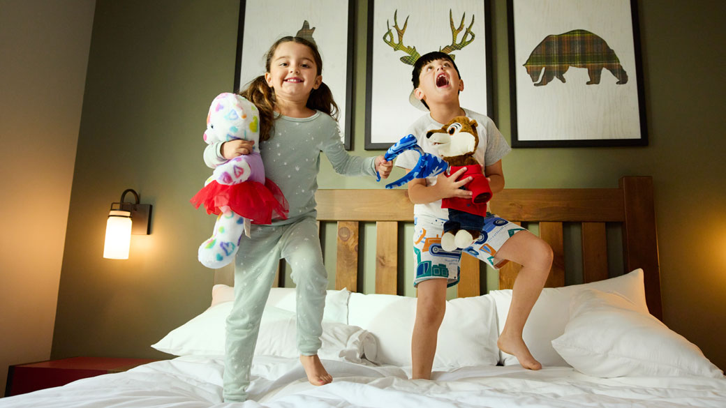 kids jumping on a queen bed