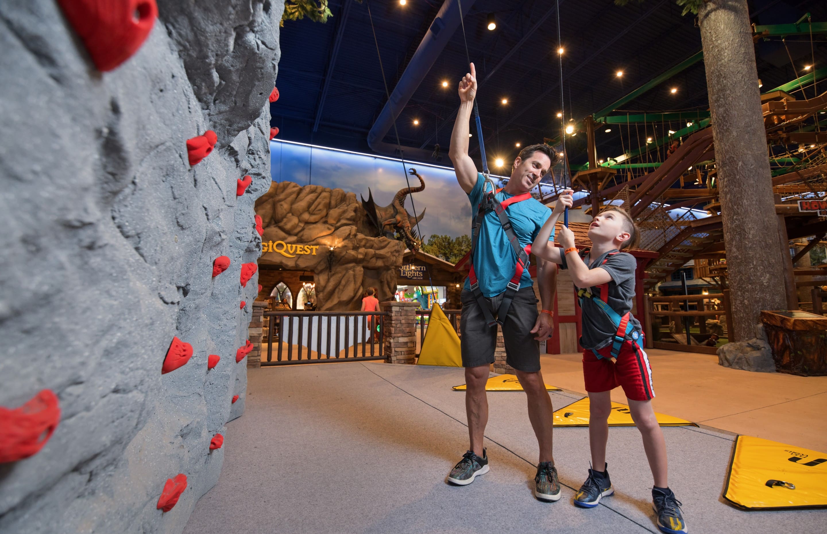 Father and his son looking at the height of the wall