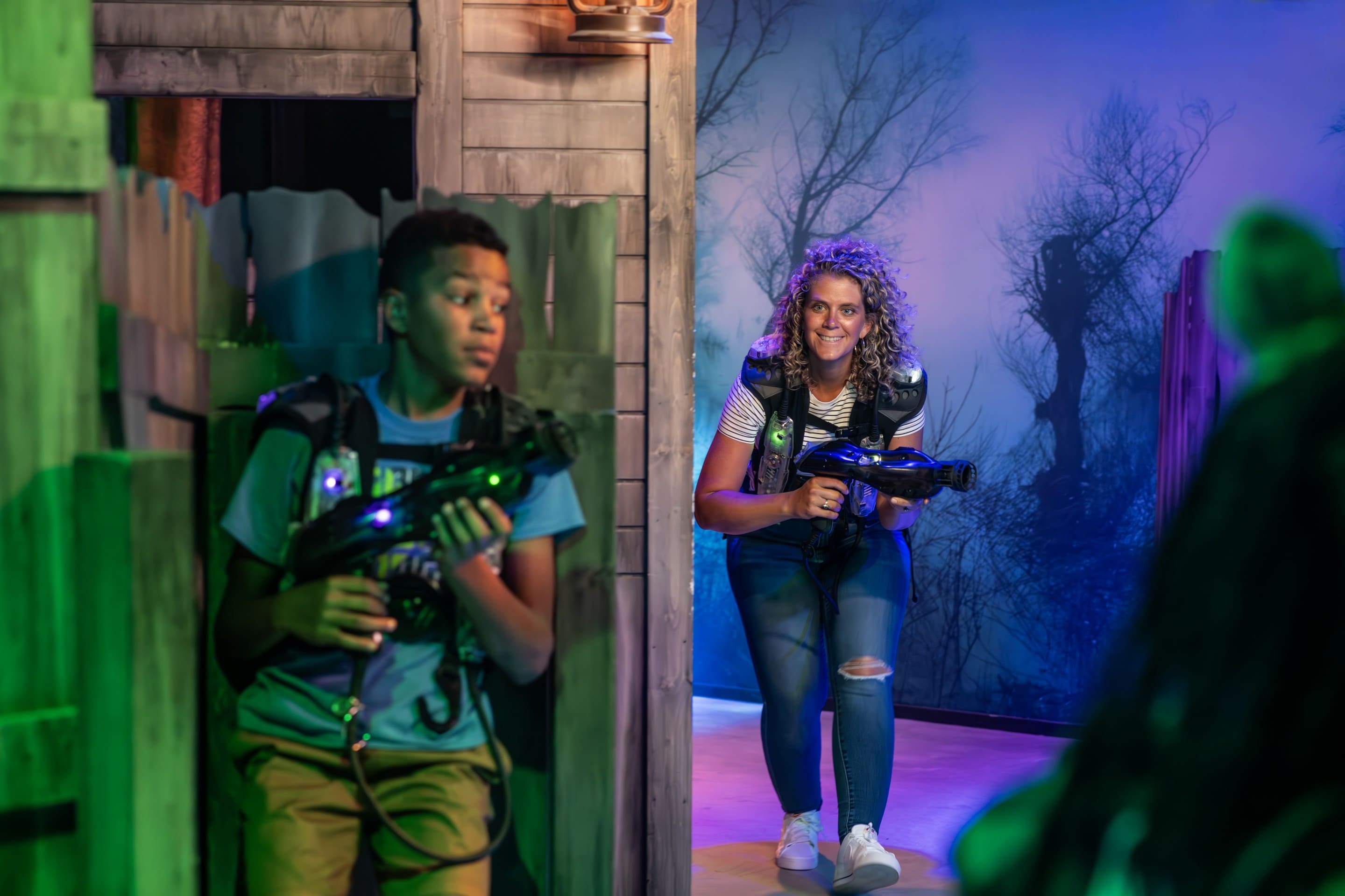 Two players sneak around during laser tag