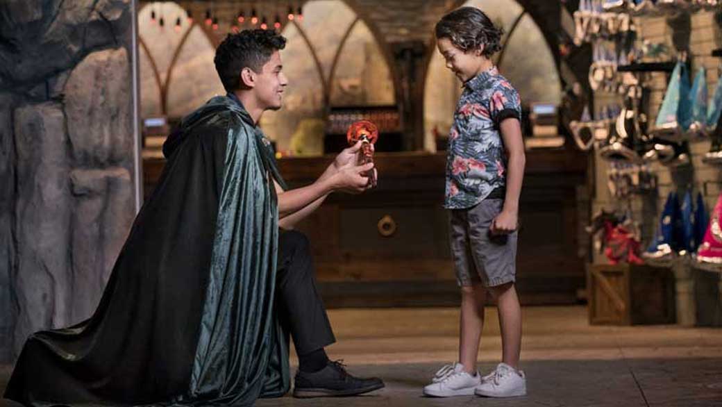 A boy playing MagiQuest with a pack member