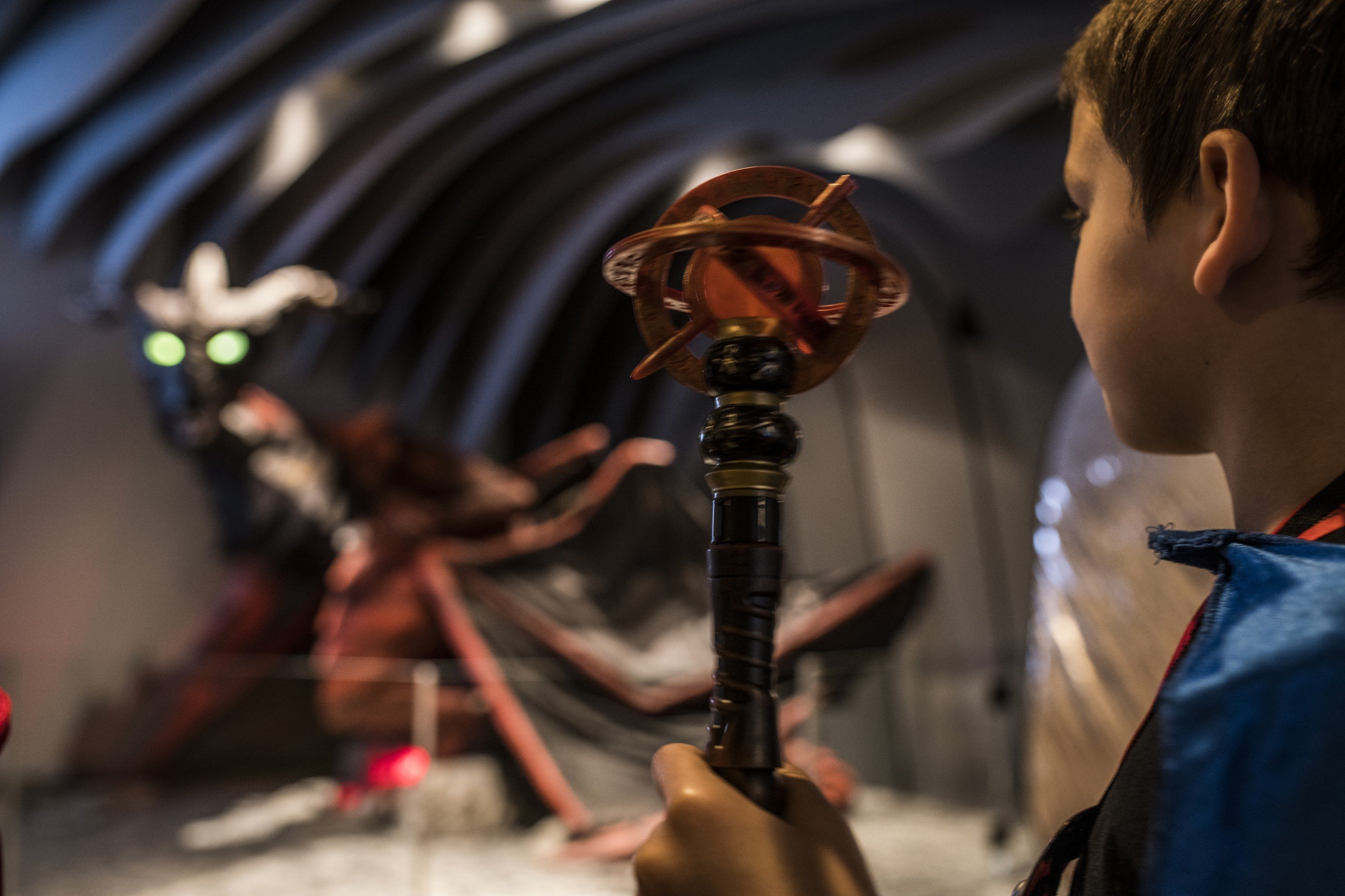 A close up of boy holding his MagiQuest wand.