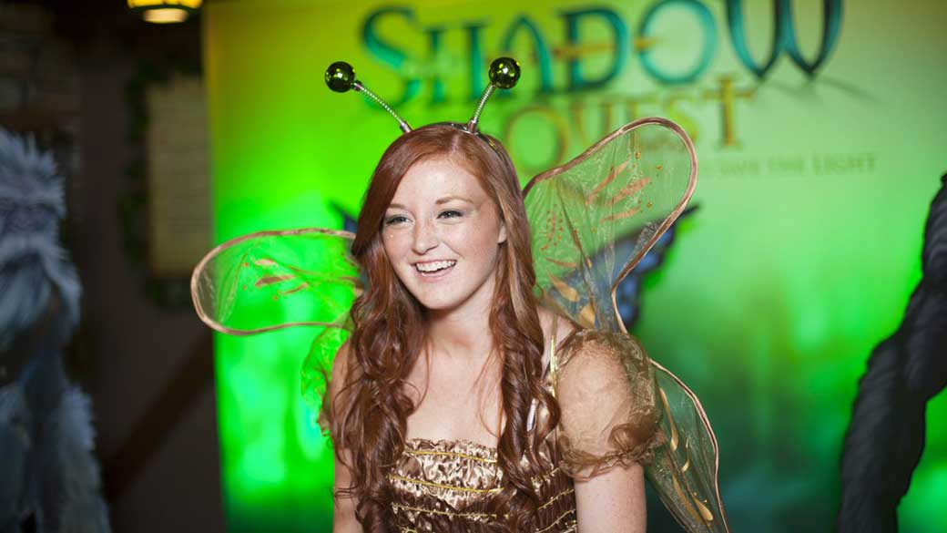 A girl dressed as fairy smiles at ShadowQuest