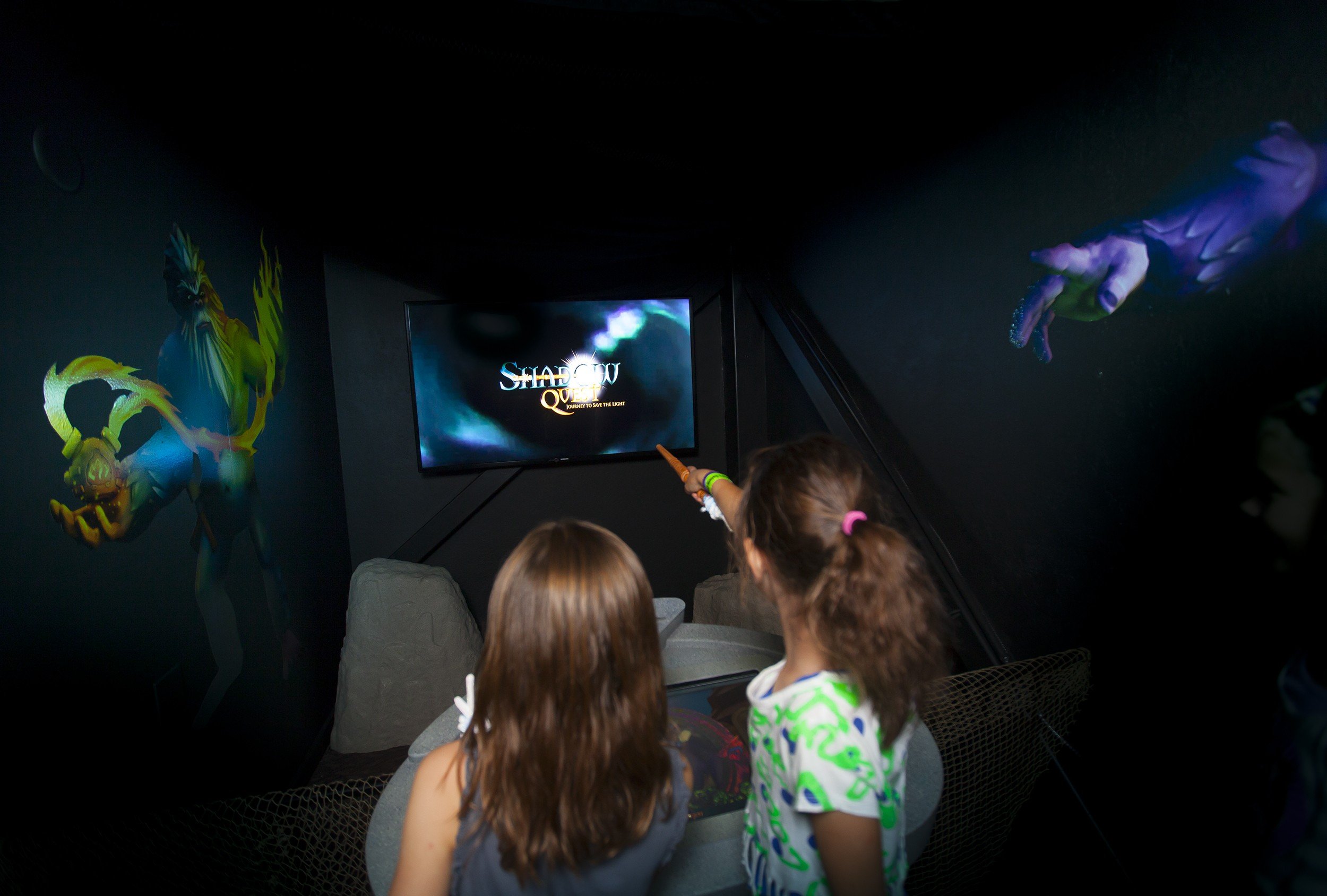 Two young girls at a shadow quest station