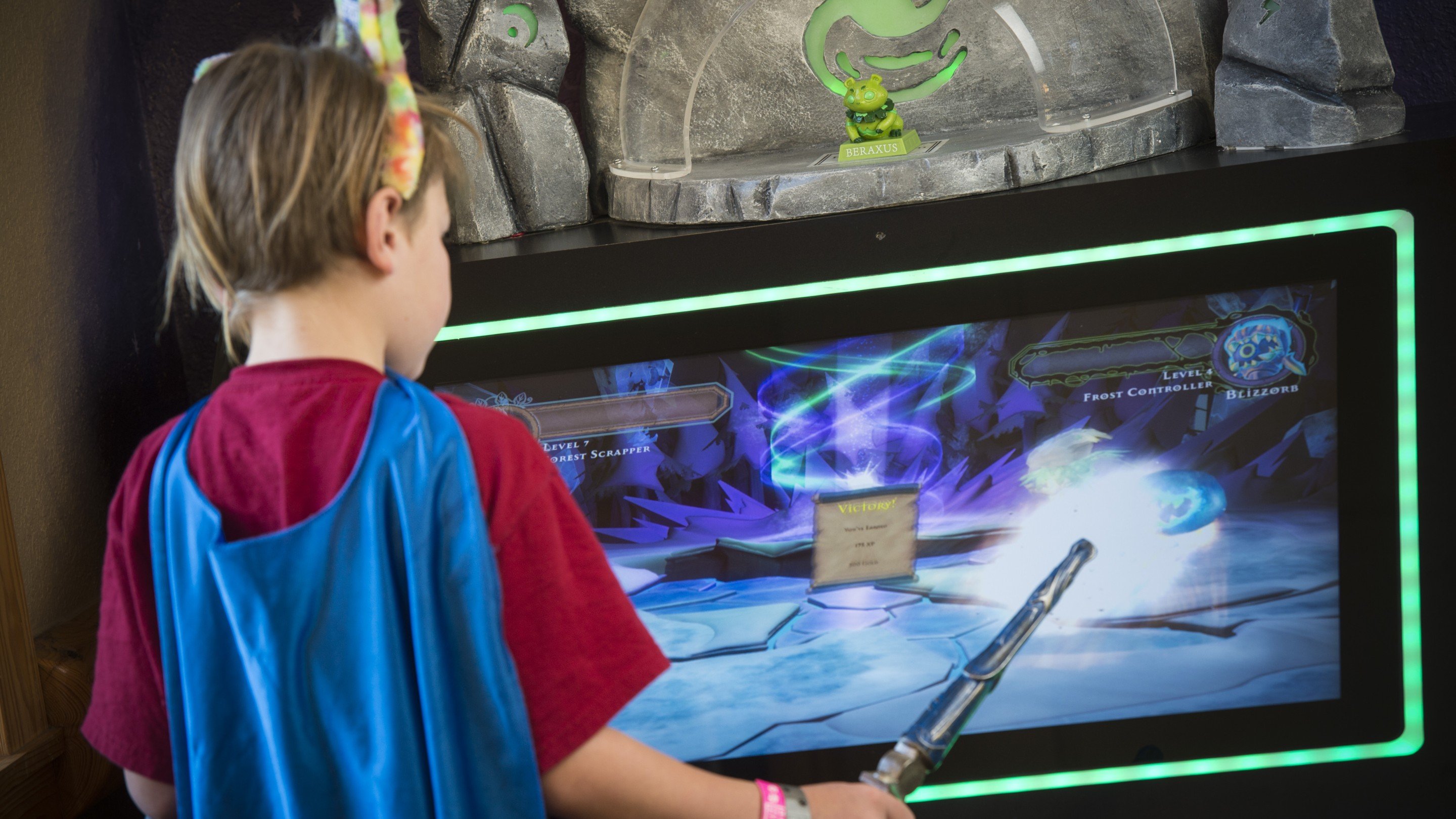 A young boy in a cape playing a level of Shadow Quest
