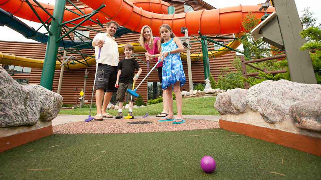 A family plays a round of mini golf at Great Wolf Lodge indoor water park and resort.