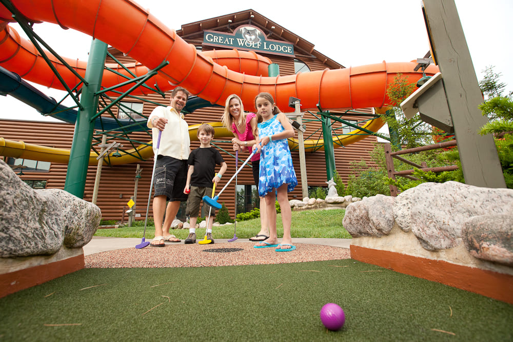 A family playing mini golf together