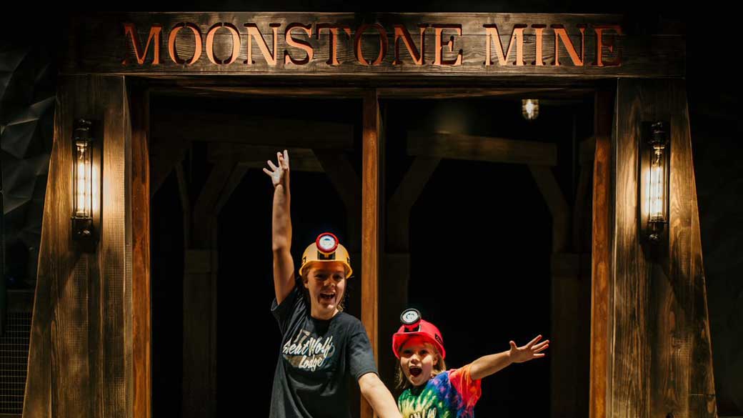 A teenager and a kid entering Moonstone Mine