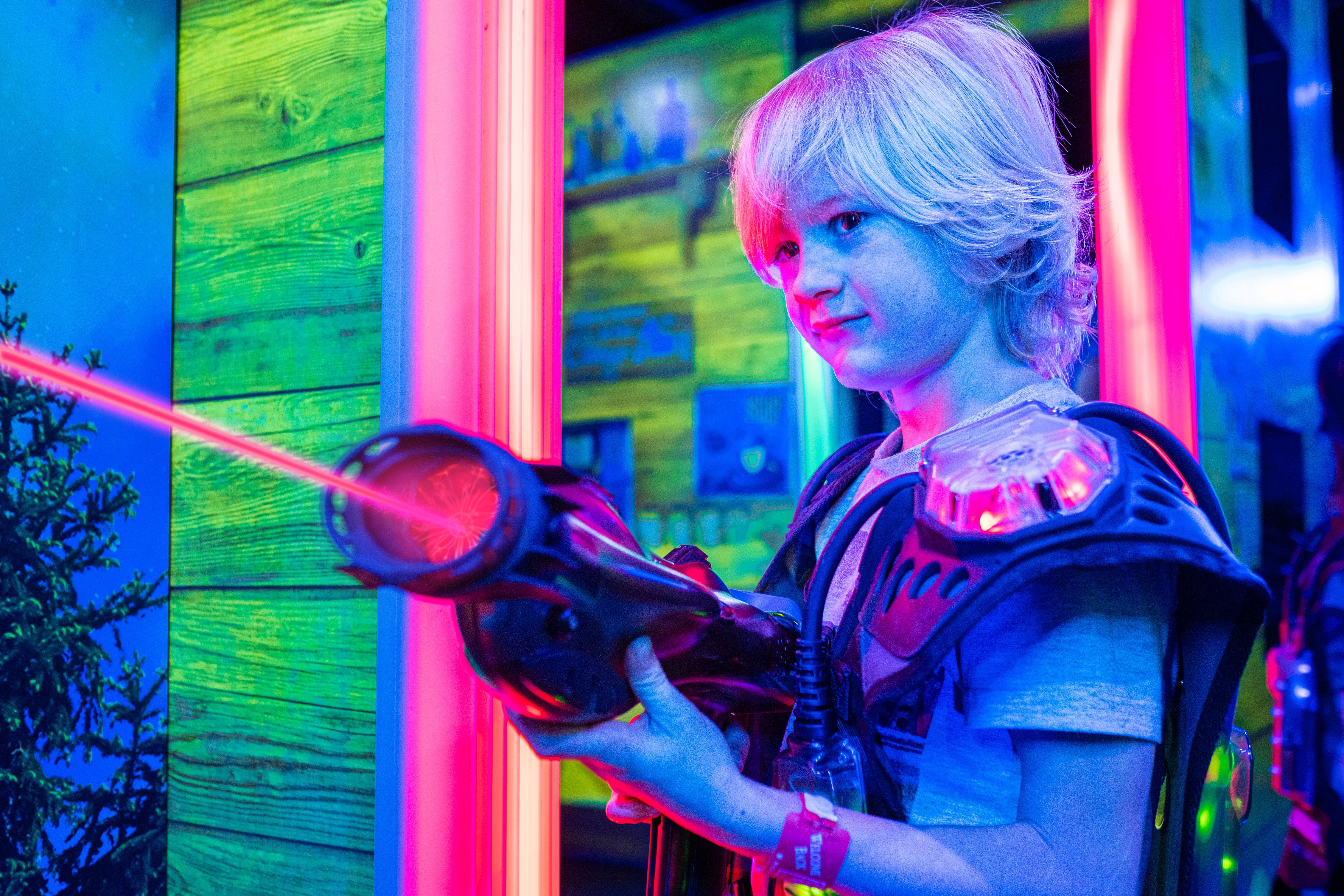 Adults and kids playing laser tag