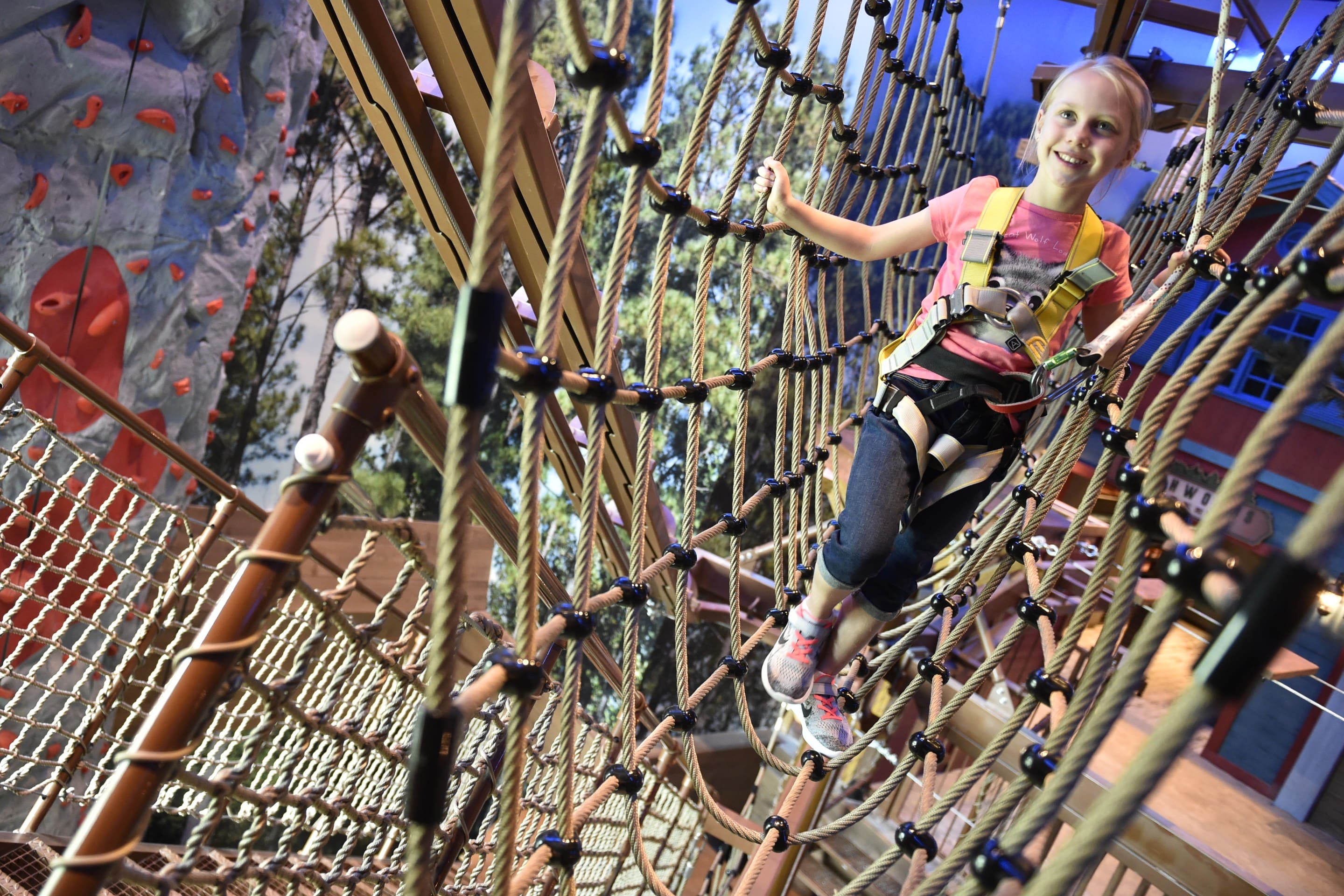 Girl trying to cross the ropes course