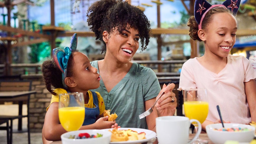 mother and daughters enjoying breakfast