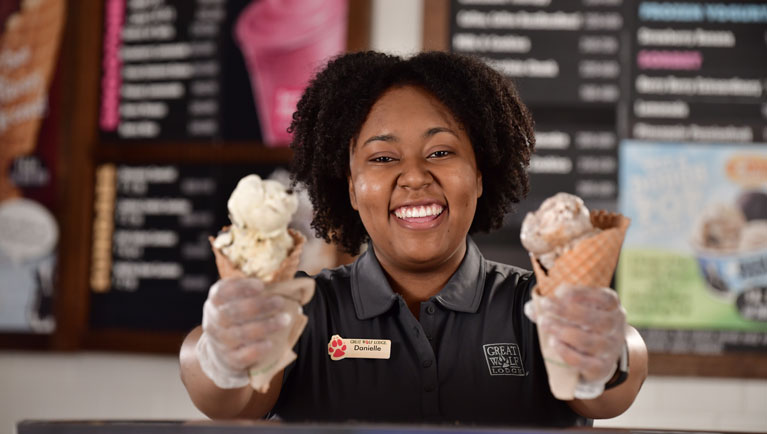 Server happily serving ice - cream