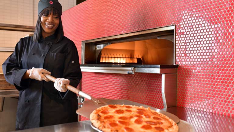 chef baking a Pizza at Hungry as a Wolf