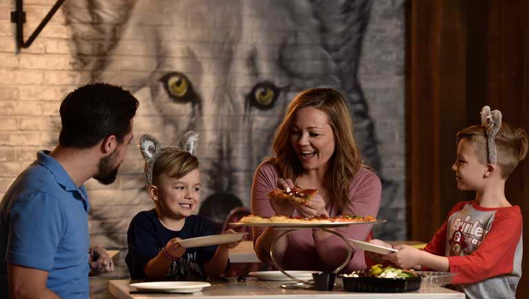 family enjoying a pizza meal