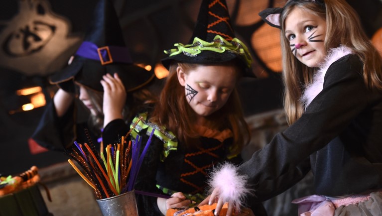Three girls doing Halloween crafts