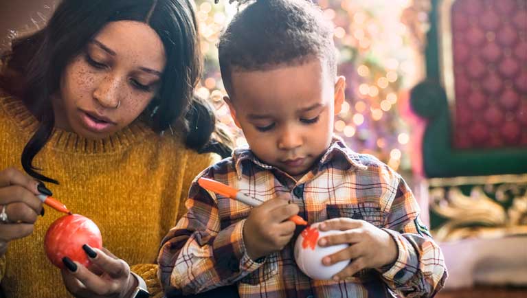 mom and son decorating a snowball